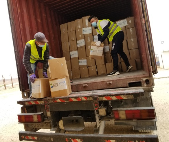 Action Against Hunger staff unload supplies in Jordan.