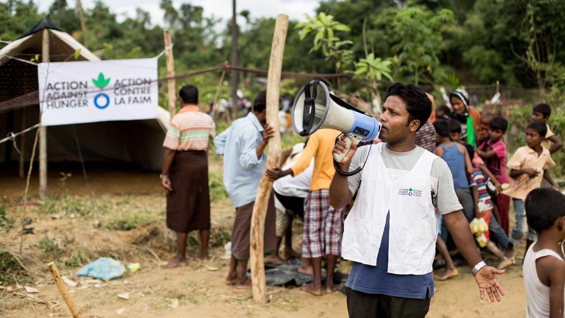 An Action Against Hunger aid worker organizes an emergency food distribution for Rohingya refugees in Cox's Bazar, Bangladesh