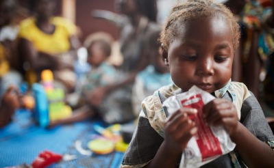 A child eats Plumpy'Nut, the ready-to-use therapeutic food that can bring malnourished children from a medical crisis to full health in as little as 45 days.