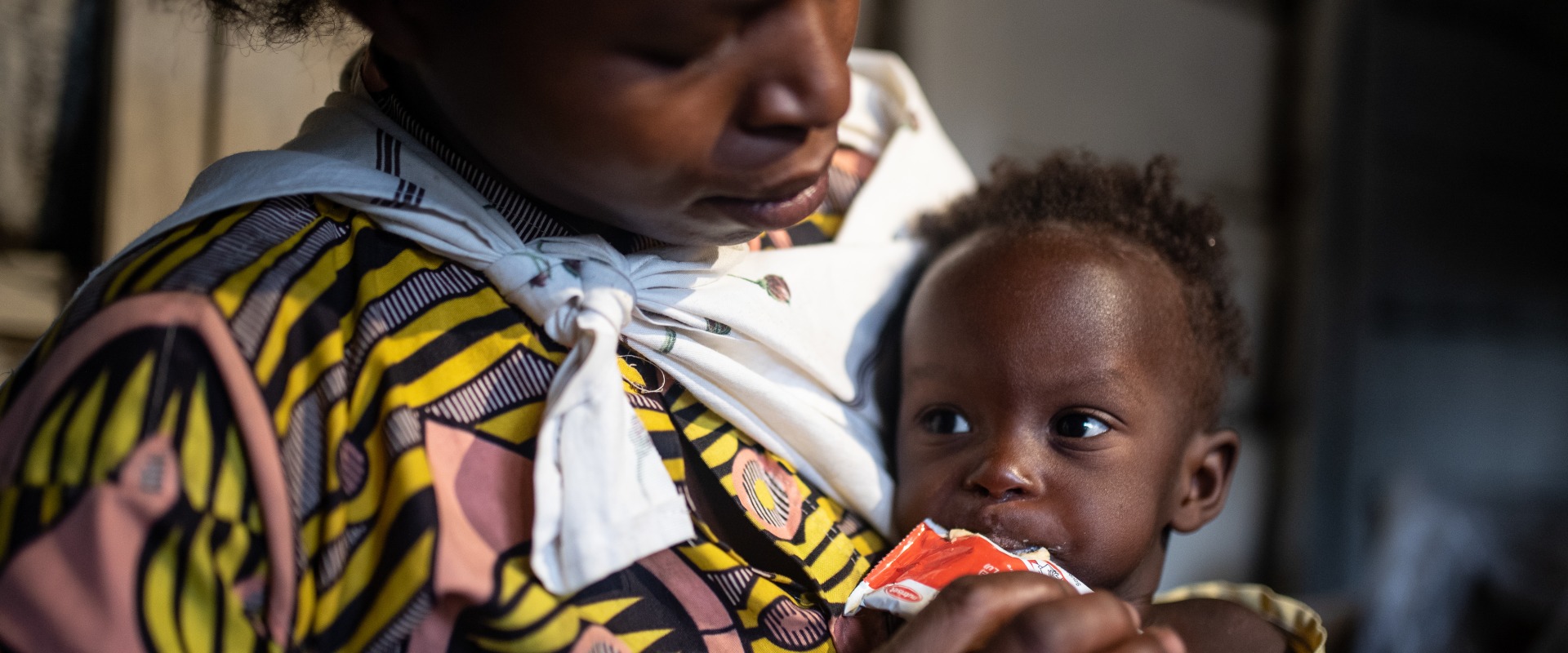 A mother feeds her child Plumpy'Nut, the peanut paste used to treat malnutrition.