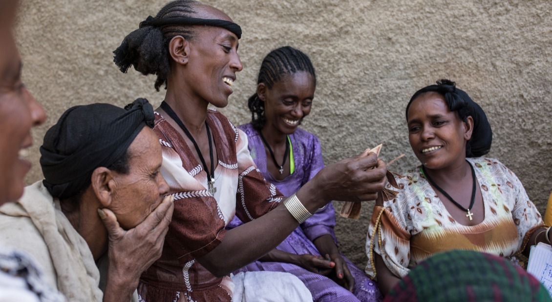 Women meet for their weekly gathering of their community savings and loans group.