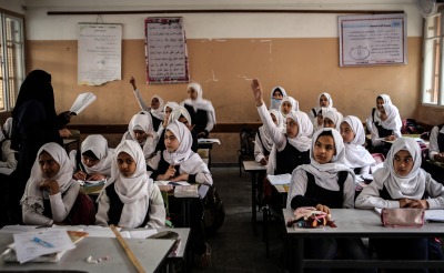 Girls learn in their classroom.