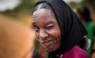 A woman winks.