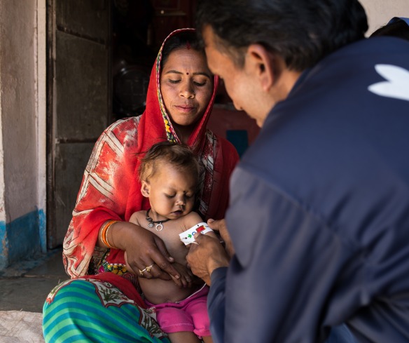 Community Health Worker Balram measures the mid-upper arm circumference of a three-year-old girl named Bhumika, and finds that she is severely malnourished.