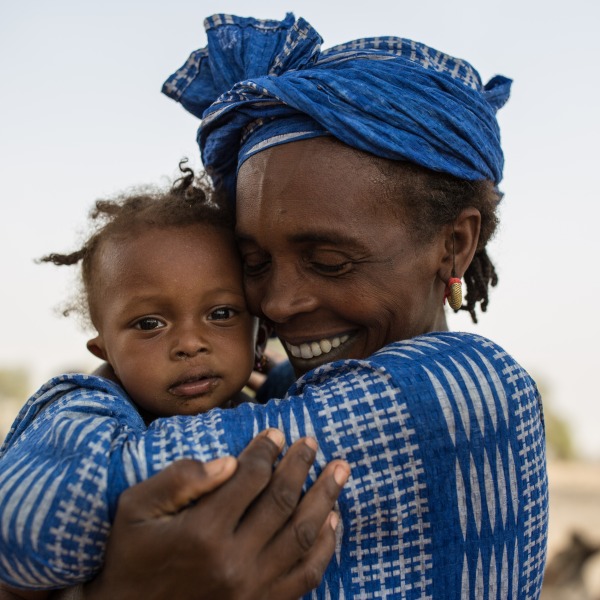 A woman hugs her daughter
