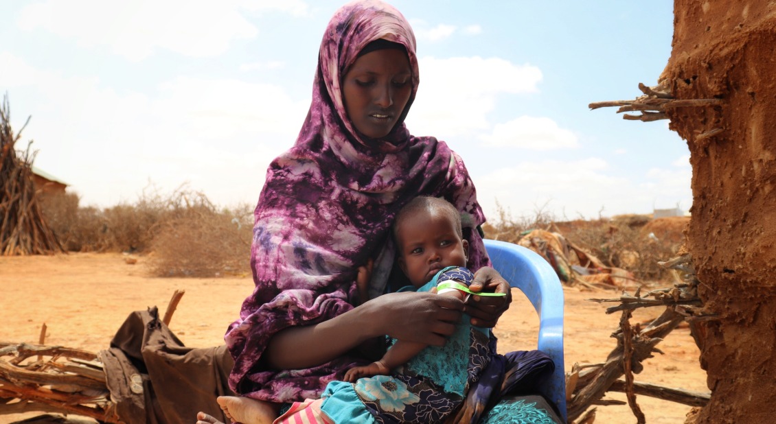 Xuhun measures her daughter Anzal's nutrition status.